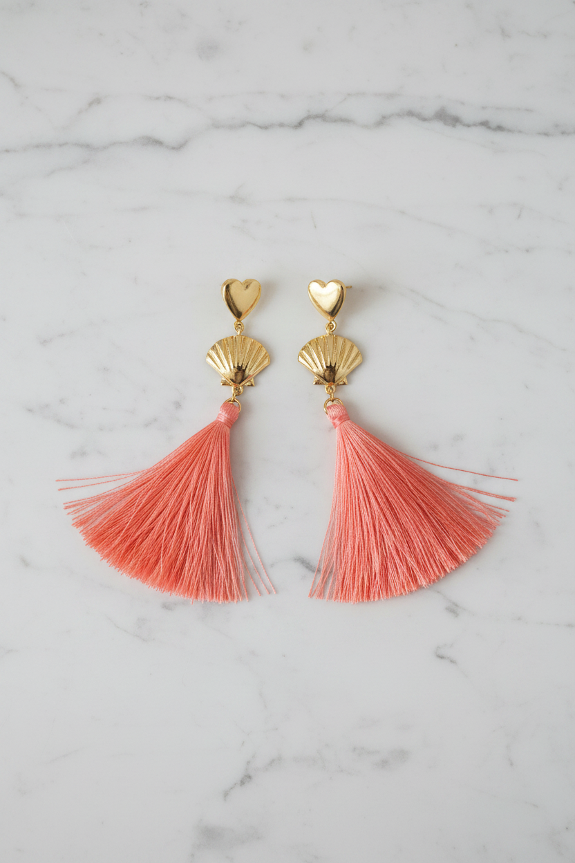 Long pink tassel statement earrings showing movement